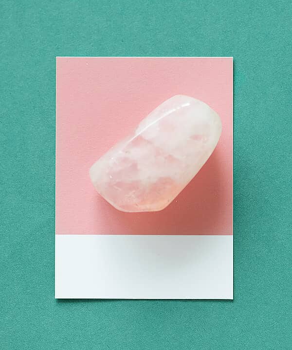 Rose quartz stone on a pink card