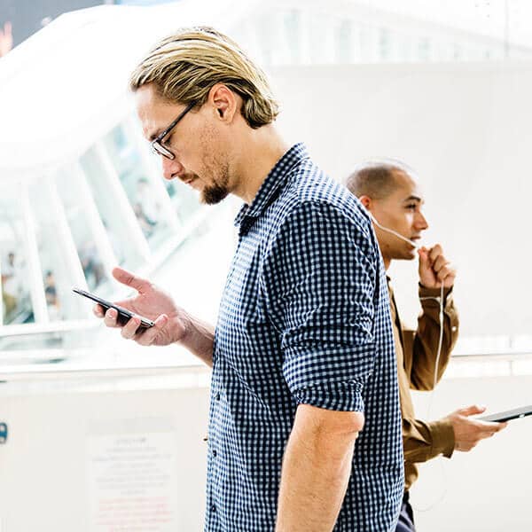 Two people using their phones